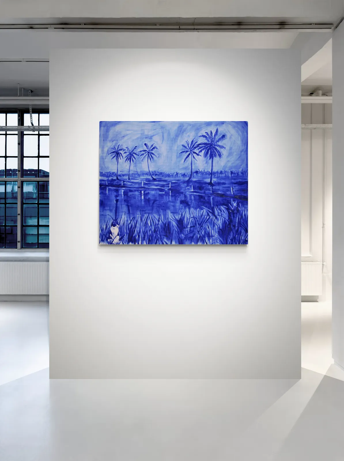 A monochromatic blue landscape featuring tall palm trees and a reflective water surface.
